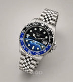Silver watch with a blue and black face on a gray background
