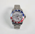 Luxury watch with a silver, blue, and red bezel on a light gray background