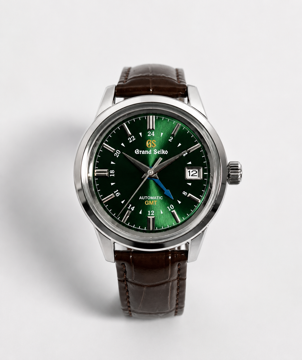 A Grand Seiko wristwatch with a polished silver-tone case, a vibrant green dial, and a dark brown leather strap, shown against a light gray background.