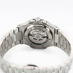 Silver watch with mechanical movement on a white background