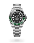 Seiko watch with black face and green bezel on a white background