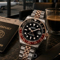 Seiko watch with rose gold and silver band on a table with a passport and coffee.