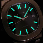 Watch with glowing green hour markers on a dark background