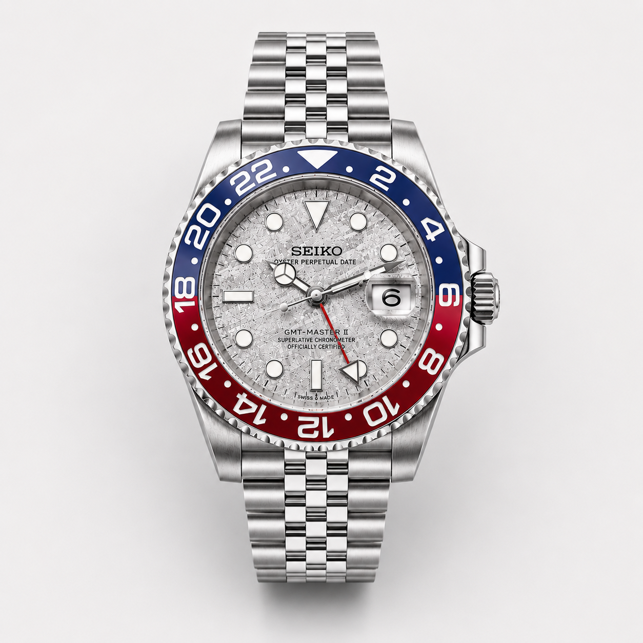 Seiko watch with a silver case, blue and red bezel on a white background