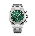 Seiko watch with green face and silver metal strap on a white background